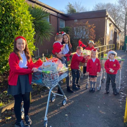The children really enjoy taking donations to the local food bank.