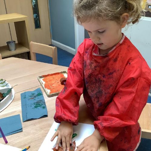 Using our knowledge of mixing secondary colours, we mixed orange and green and used leaves to create small scale prints.